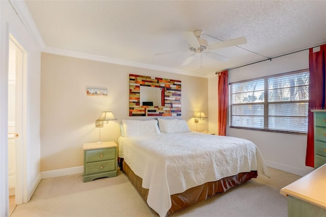 carpeted bedroom with ensuite bath, ceiling fan, crown molding, and a textured ceiling