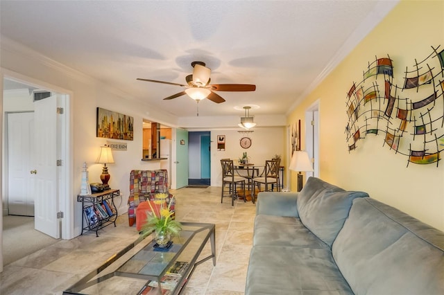 living room featuring ceiling fan and ornamental molding