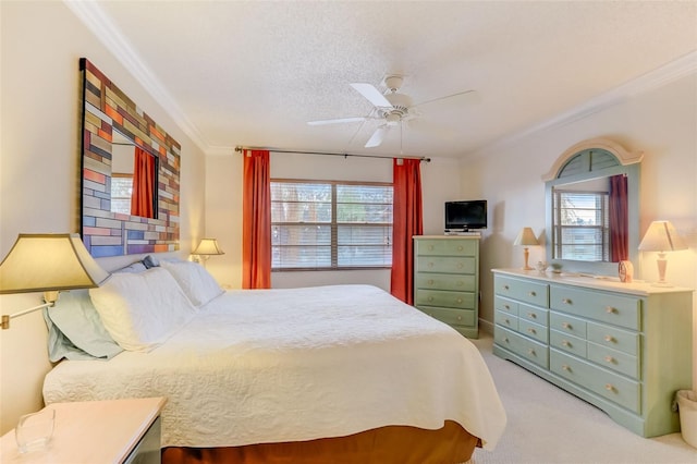 carpeted bedroom with multiple windows, ceiling fan, a textured ceiling, and ornamental molding