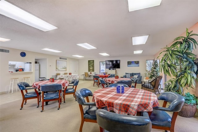 dining space with light carpet