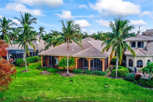 view of front of house with a sunroom and a front lawn