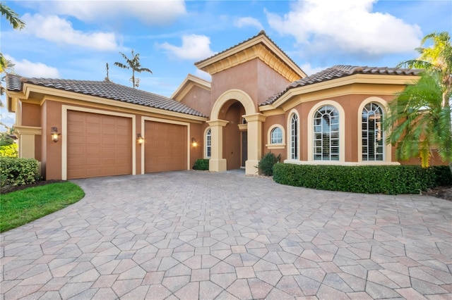 mediterranean / spanish house featuring a garage