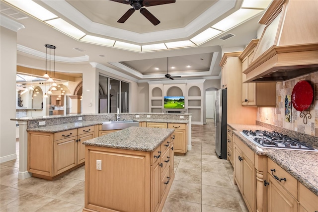 kitchen with sink, custom range hood, a kitchen island, kitchen peninsula, and stainless steel appliances