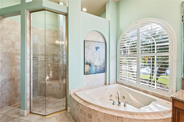 bathroom featuring tile patterned flooring, vanity, shower with separate bathtub, and a wealth of natural light