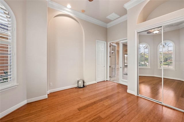 interior space with crown molding and hardwood / wood-style flooring