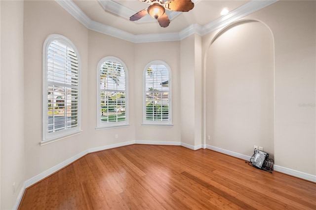 unfurnished room with light hardwood / wood-style floors, ceiling fan, and crown molding