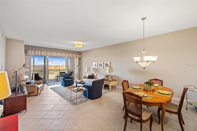 living room featuring baseboards, light tile patterned floors, and a notable chandelier