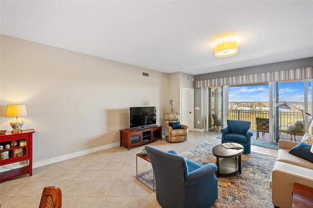 living area with light tile patterned flooring, visible vents, and baseboards