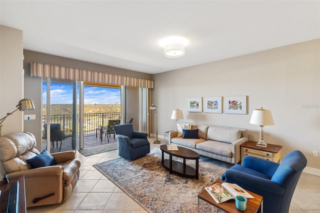living area featuring baseboards and light tile patterned floors