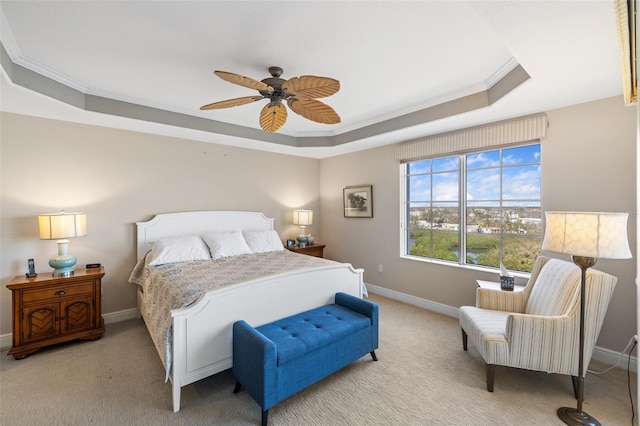 bedroom with ornamental molding, ceiling fan, light colored carpet, and a raised ceiling