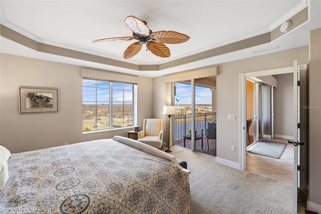 tiled bedroom with ornamental molding, access to exterior, a tray ceiling, and ceiling fan