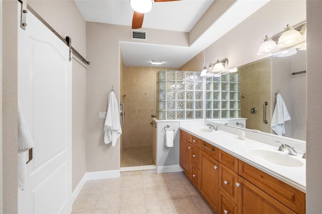 full bathroom featuring a walk in shower, visible vents, ceiling fan, and a sink