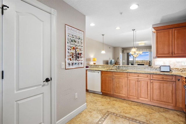 kitchen with light stone countertops, decorative light fixtures, white dishwasher, a sink, and baseboards
