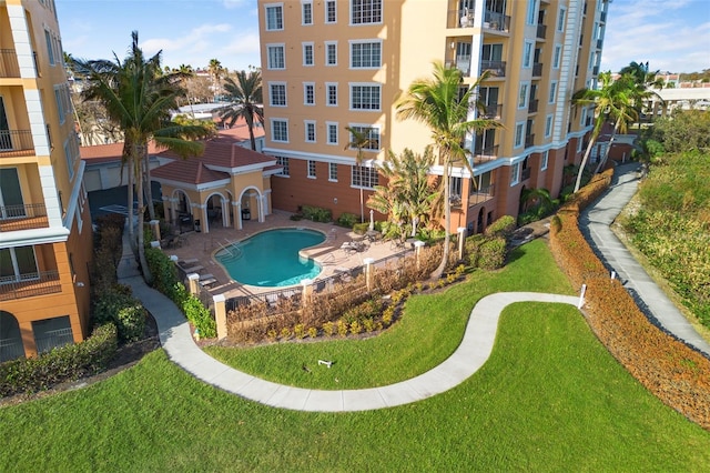 view of swimming pool featuring a patio and a lawn