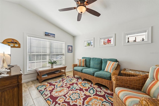 living room with ceiling fan, light wood-type flooring, lofted ceiling, and plenty of natural light