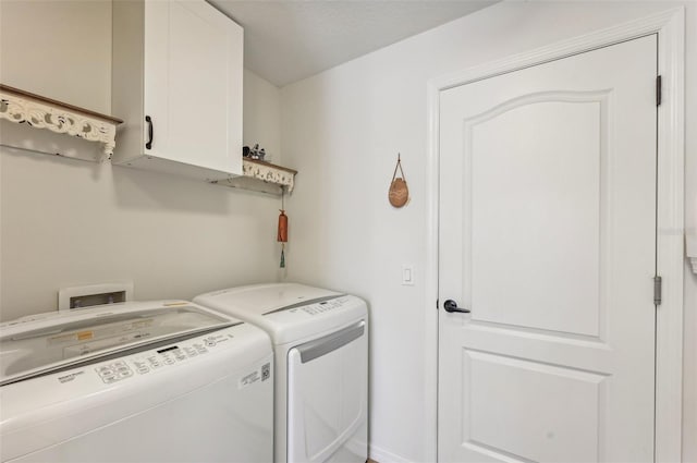 laundry room with independent washer and dryer and cabinets