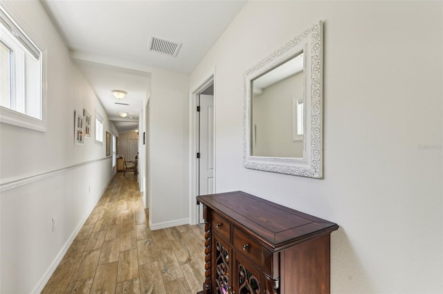 corridor featuring light hardwood / wood-style floors