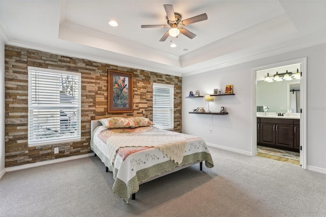 bedroom with ceiling fan, a raised ceiling, crown molding, and light colored carpet