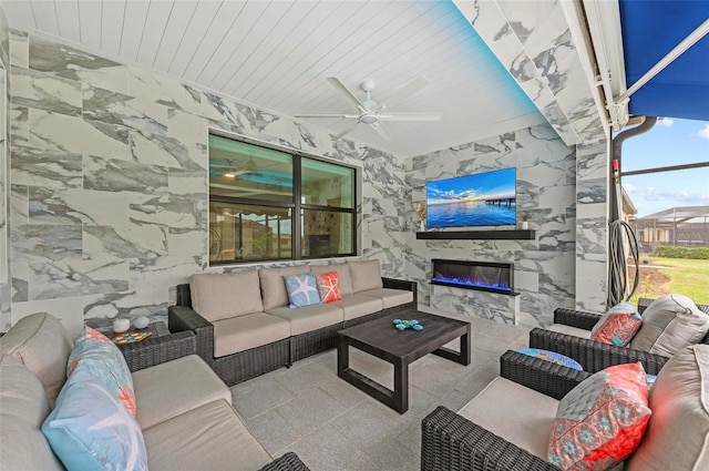 living room featuring ceiling fan, a fireplace, wood ceiling, and tile walls