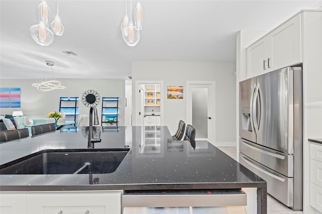 kitchen with white cabinets, pendant lighting, stainless steel appliances, and sink