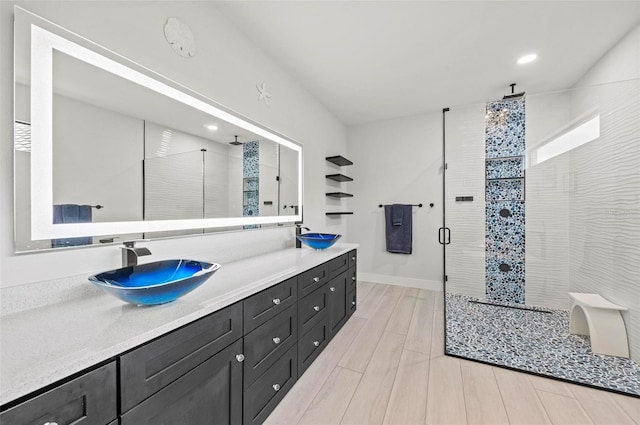 bathroom featuring wood-type flooring, vanity, and walk in shower