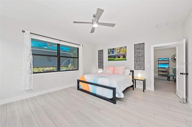 bedroom with ceiling fan and light hardwood / wood-style flooring