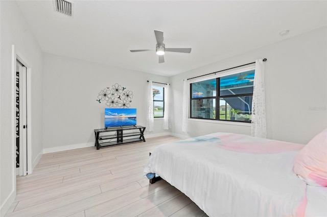 bedroom with ceiling fan and light wood-type flooring