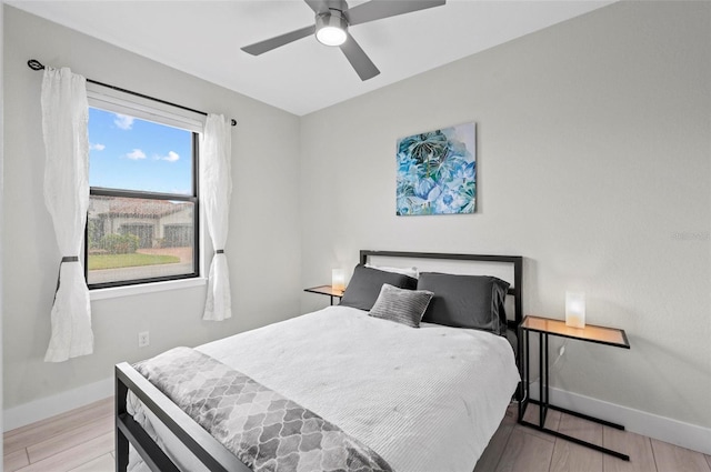 bedroom with ceiling fan and light wood-type flooring