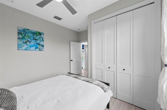 bedroom featuring light wood-type flooring, a closet, and ceiling fan