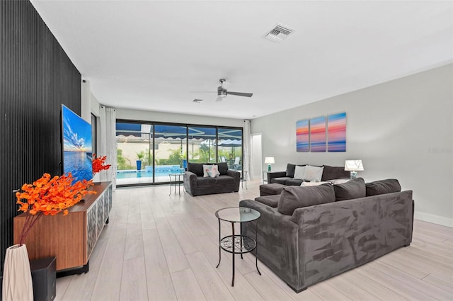 living room featuring ceiling fan and light hardwood / wood-style floors