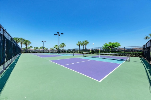 view of tennis court with basketball hoop