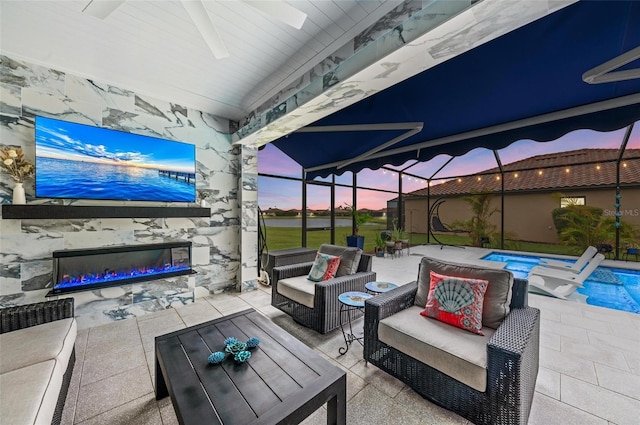 view of patio with an outdoor living space with a fireplace and glass enclosure