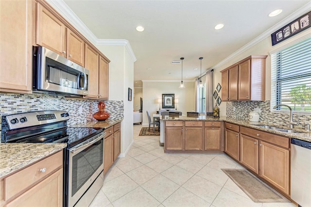 kitchen with kitchen peninsula, decorative light fixtures, crown molding, appliances with stainless steel finishes, and sink