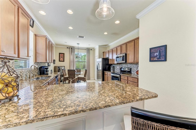 kitchen with kitchen peninsula, stainless steel appliances, light stone counters, and sink