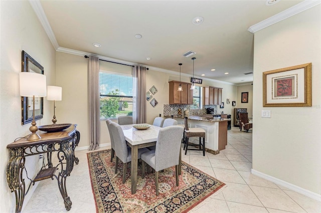 dining area with crown molding and light tile patterned flooring