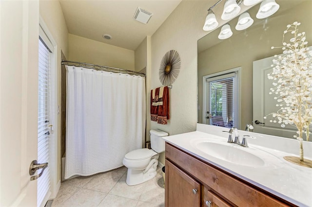 full bathroom featuring toilet, vanity, tile patterned floors, and shower / bath combo with shower curtain