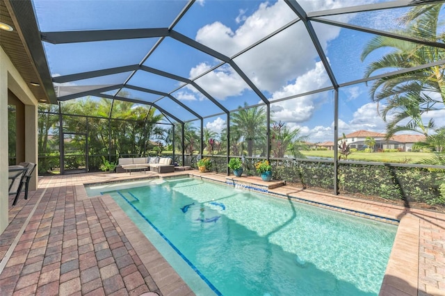 view of swimming pool with an outdoor hangout area, a patio, and glass enclosure