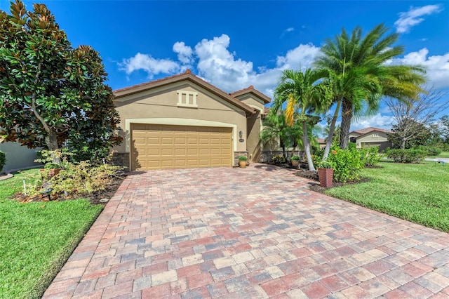 view of front of house with a garage and a front lawn