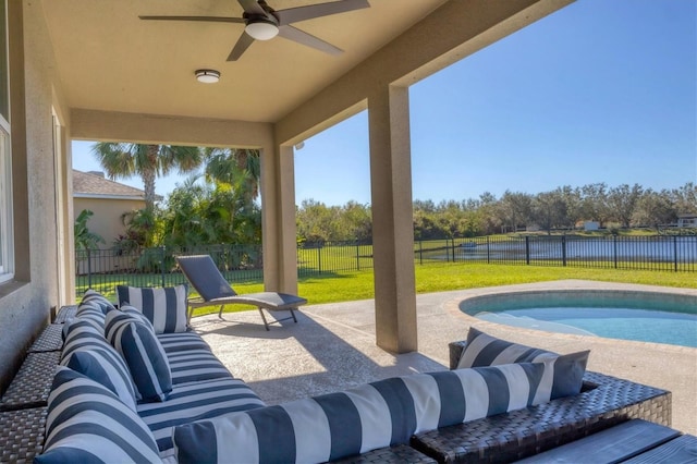 view of patio / terrace with a fenced in pool, an outdoor hangout area, a water view, and ceiling fan