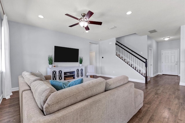 living room featuring ceiling fan and dark hardwood / wood-style floors