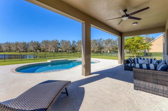 view of pool featuring a patio area, a yard, a water view, and ceiling fan