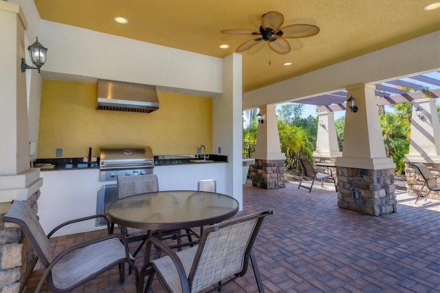 view of patio / terrace featuring exterior kitchen, ceiling fan, sink, and grilling area