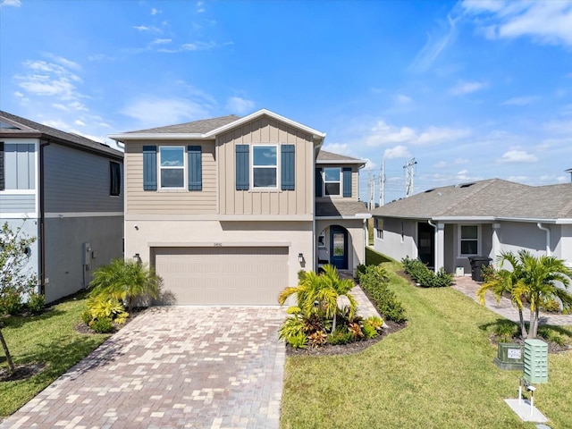 view of front of home featuring a front lawn and a garage