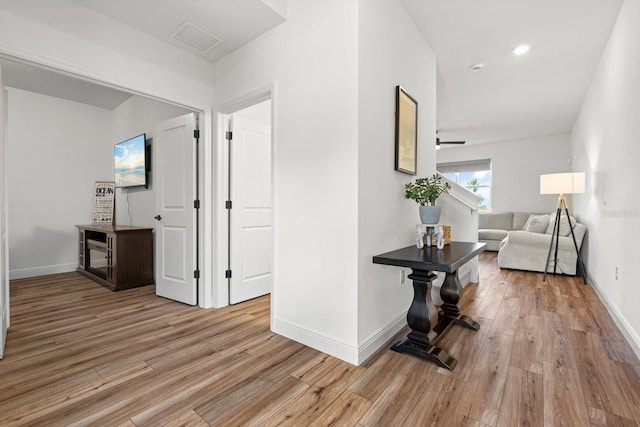 corridor with light hardwood / wood-style floors