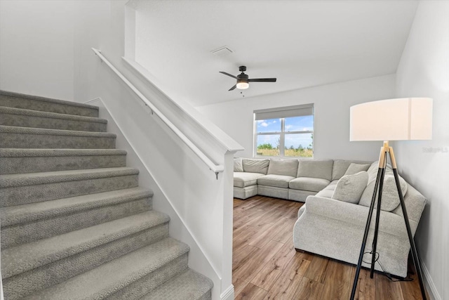 living room with wood-type flooring and ceiling fan