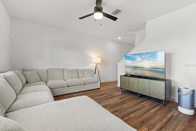 living room with dark hardwood / wood-style floors and ceiling fan