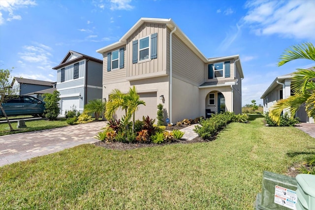 view of front of house with a front yard and a garage