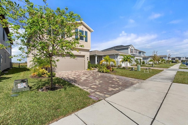 view of front of home with a garage and a front lawn