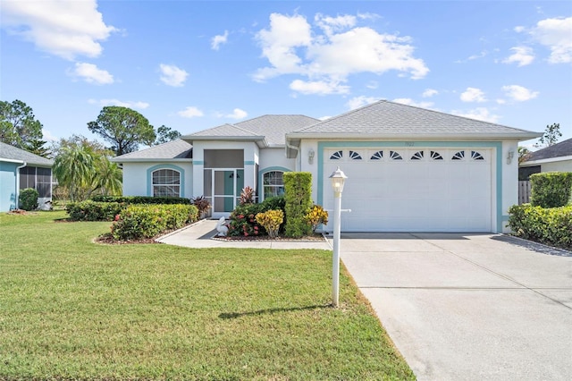 view of front of home with a front yard and a garage