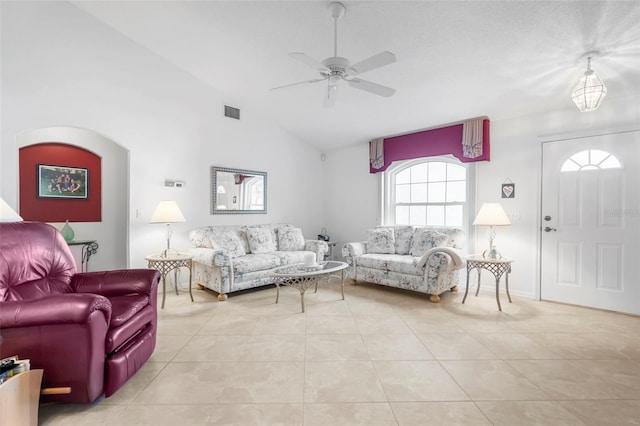 living room featuring vaulted ceiling, light tile patterned floors, and ceiling fan